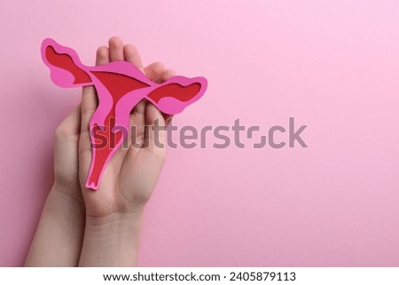 Reproductive medicine. Woman holding paper uterus on pink background, top view with space for text Stock photo © 