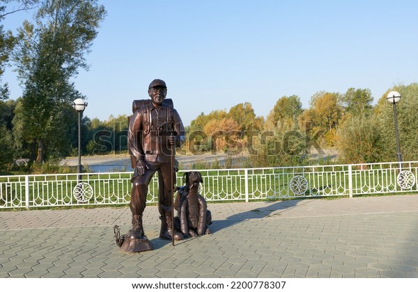 Republic of Altai, Altai Territory, Russia -\
September 07, 2022. Tourist Monument (Pilgrim) - a man in a cap\
with his faithful friend the dog.\
