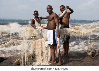 REPUBLIC OF CONGO, SUBURB OF BRAZZAVILLE - MAY 09, 2007: Young men catch fish on the bank of the river of Congo. Republic of Congo, suburb of Brazzaville, May 09, 2007.