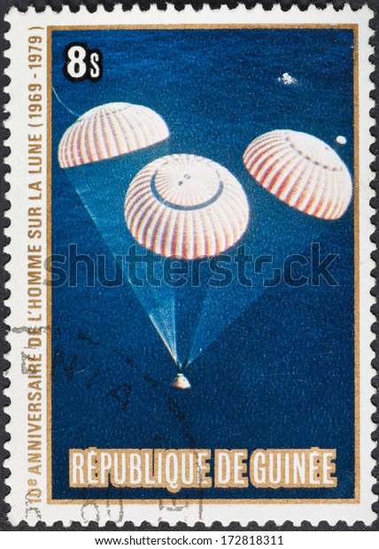 REPUBLIC OF GUINEA - CIRCA 1979: A\
postage stamp printed in the Republic of Guinea shows the Apollo 11\
Moon Landing and first step on The Moon surface, circa\
1979