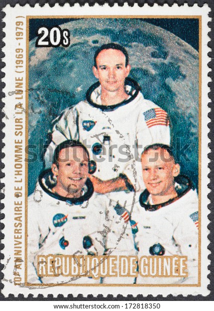REPUBLIC OF GUINEA - CIRCA 1979: A postage stamp\
printed in the Republic of Guinea shows Apollo 11 Moon Landing and\
first step on The Moon surface - portrait Armstrong, Collins,\
Aldrin, circa 1979