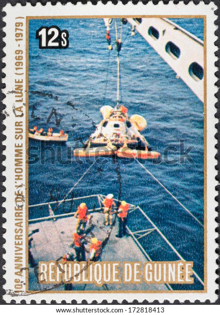REPUBLIC OF GUINEA\
- CIRCA 1979: A postage stamp printed in the Republic of Guinea\
shows the Apollo 11 Moon Landing and first step on The Moon surface\
- landing on water, circa\
1979