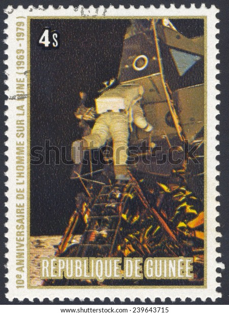 REPUBLIC OF\
GUINEA - CIRCA 1979: A postage stamp printed in the Republic of\
Guinea shows the Apollo 11 Moon Landing and first step on The Moon\
surface - flying on the Moon, circa\
1979