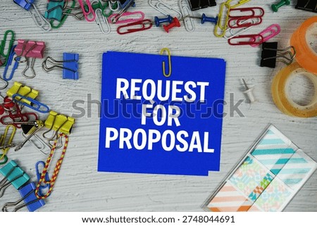 Request For Proposal text on stick note with stationery on concrete background
