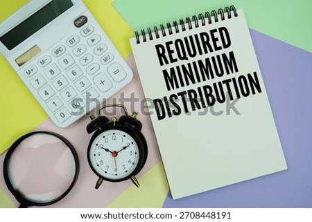 Required Minimum Distribution text with calculator, alarm clock and magnifying glass