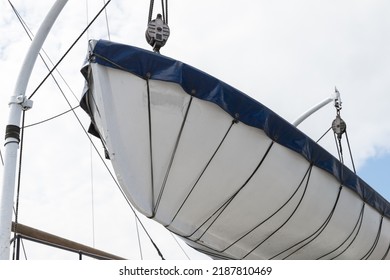 A Rescue Boat Is On A Passenger Ferry Above White Sky Background. Marine Safety Equipment