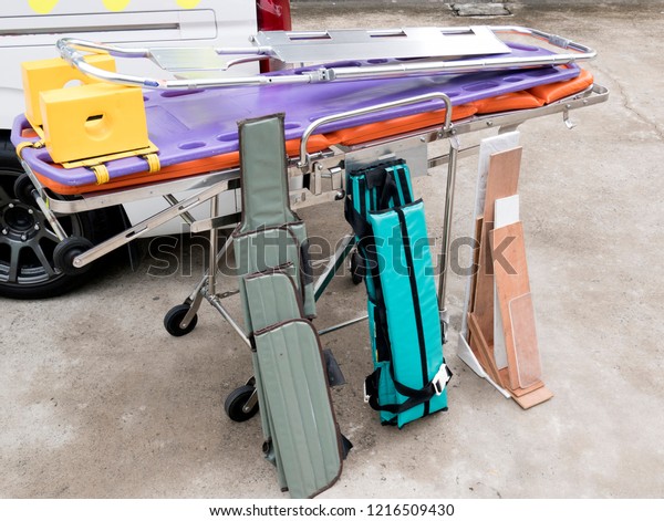Rescue equipment is placed beside emergency\
ambulance van.