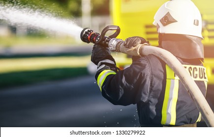 Rescue Firefighter Man Battle A Wildfire. Firefighter In Uniform And  Helmet.