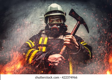 Rescue firefighter man in a fire holds iron axe.