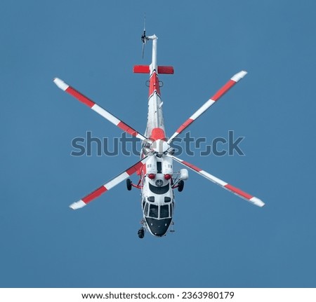 Rescue helicopter in action. Rescue workers are transported. Operational flight. Aircraft. Top View.