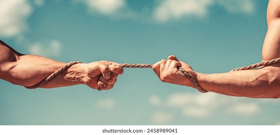 Rescue, help, helping gesture or hands. Conflict, tug of war. Two hands, helping hand, arm, friendship. Hand holding a rope, climbing rope, strength and determination. - Powered by Shutterstock