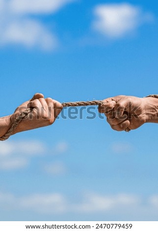 Rescue, help, helping gesture or hands. Conflict tug of war. Rope, cord. Hand holding a rope, climbing rope, strength and determination. Strong hold. Two hands, helping hand of a friend.