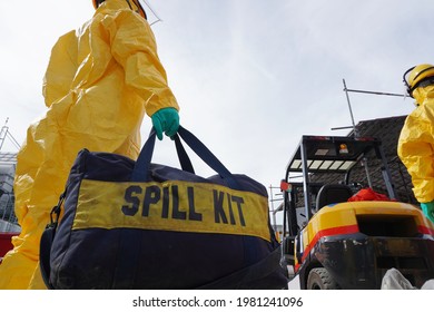 Rescue personnel wear yellow chemical protective clothing during chemical spill recover as part of emergency drills at chemical plant.