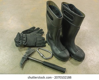 Rescue Rope, Axe, Carbine, Boots And Gloves Of A Firefighter. Firefighters' Equipment. Special Clothing To Protect Firefighters From Injury. Means Of Rescue In Case Of Fire At Altitude.