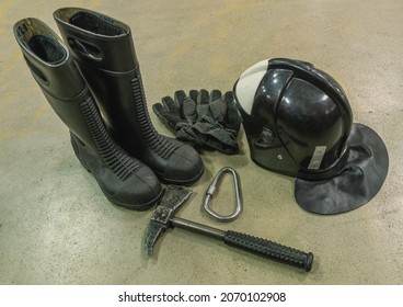 Rescue Rope, Axe, Carbine, Boots And Gloves Of A Firefighter. Firefighters' Equipment. Special Clothing To Protect Firefighters From Injury. Means Of Rescue In Case Of Fire At Altitude.