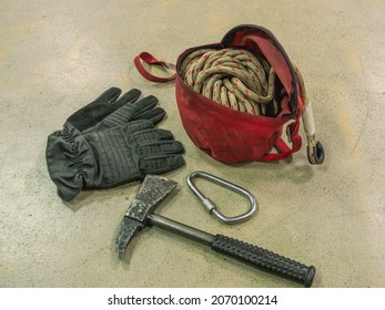 Rescue Rope, Axe, Carbine And Firefighter Gloves. Firefighters' Equipment. Means Of Rescue In Case Of Fire At Altitude.