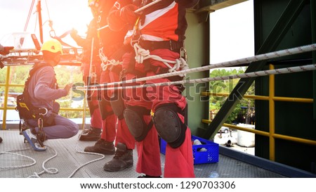 Rescue team in action practicing training for the use of ropes for rescue of high buildings . selective focus .  Concept for team ,teamwork and rescue.