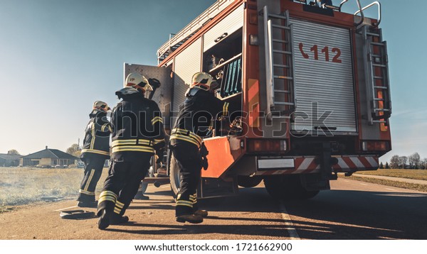Rescue Team of Firefighters Arrive on the Car\
Crash Traffic Accident Scene on their Fire Engine. Firemen Grab\
their Tools, Equipment and, Gear from Fire Truck, Rush to Help\
Injured, Trapped People