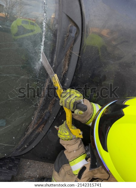 The rescue team of firefighters at the scene of the\
traffic accident of the car accident. Firefighters grab their\
tools, gear, and equipment and rush to help injured and trapped\
people.cutting  glass