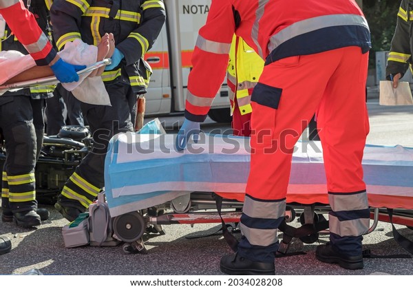 Rescue workers\
place victims on rescue\
stretcher