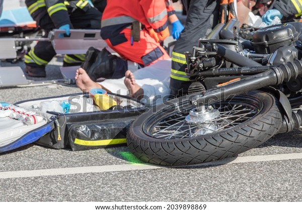 Rescue workers are trying to recover a
seriously injured
motorcyclist