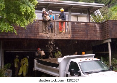 Rescue Workers Trying To Save Man Buried In Mud Slide Behind House, Mill Valley, California