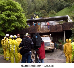 Rescue Workers Trying To Save Man Buried In Mud Slide Behind House, Mill Valley, California