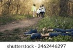 Rescuers group finding murdered barefoot victim in the forest, scared people calling the police. Mysterious horror manslaughter in the woods, civilians found a dead body, grim murder. Camera B.