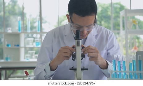 Research concept of 4k resolution. Asian scientists are examining the anomaly with a microscope. - Shutterstock ID 2203247967