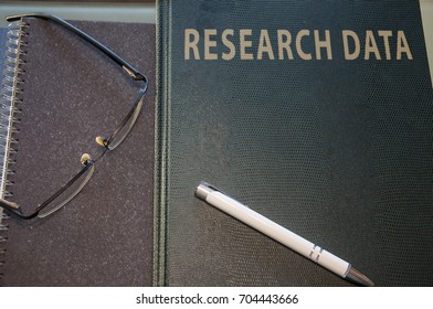 research data to be studied, pen and glasses