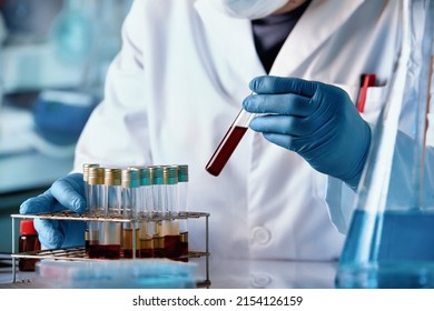 Research doctor holding Blood sample of patient for development test in laboratory. Scientist holding Blood tube for analysis in the hematology laboratory