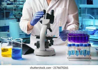 Research Engineer Working On The Microscope With A Tube In The Microbiology And Research Laboratory. Microbiologist Scientist Analyzing A Sample Under A Microscope In The Science Lab