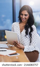 Research Is Essential To Staying Current And Up-to-date. Cropped Shot Of A Beautiful Young Businesswoman Working On A Digital Tablet In A Modern Office.