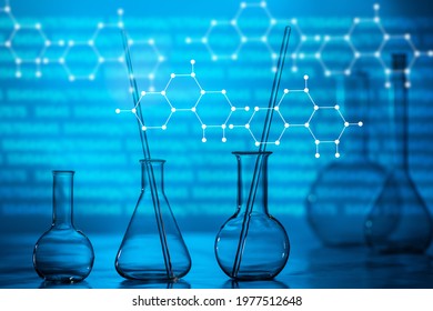 Research in the field of chemistry and medicine. Glass chemical dishes on the background of chemical schemes. Empty flasks in a chemical laboratory. Science laboratory. Lab test. Scientific experiment