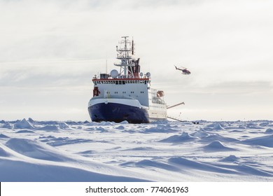 Research icebreaker and a helicopter while setting up an ice camp - Powered by Shutterstock