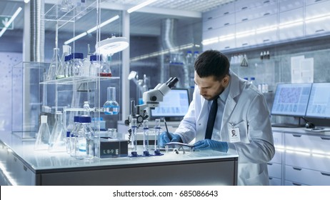 Research Scientist Writes Down Observations. He's Conducts Experiments in Modern Laboratory.