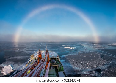 Research Ship Going Under White Rainbow Through The Ice In Arctic Ice In East-Siberian Sea, Arctic Ocean. White Rainbow Is Rare Meteorological Phenomenon. 
