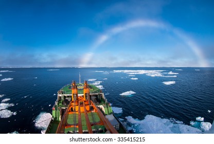 Research Ship Going Under White Rainbow Through The Ice In Arctic Ice In East-Siberian Sea, Arctic Ocean. White Rainbow Is Rare Meteorological Phenomenon. 
