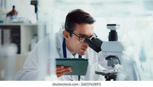Research, tablet or man in lab with microscope, vaccine test or medical experiment for cancer treatment. Biotech, check or scientist with science, study or sample with cure, particles or bacteria