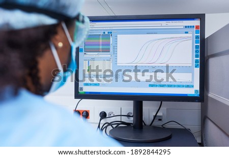 Researcher analyzing data on the computer in the laboratory at Covid-19 vaccine research