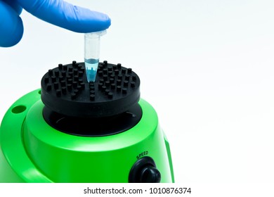 Researcher dissolves compound in solvent by vortex mixer
