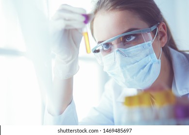 Researcher, doctor, scientist or laboratory assistant working with plastic medical tubes in modern lab or hospital.