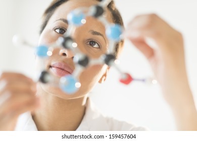 Researcher examining molecular structure in laboratory - Powered by Shutterstock