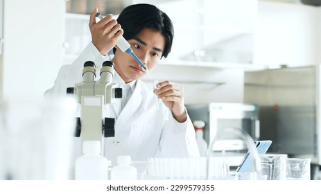 Researcher experimenting in the lab. Scientific experiment. - Powered by Shutterstock