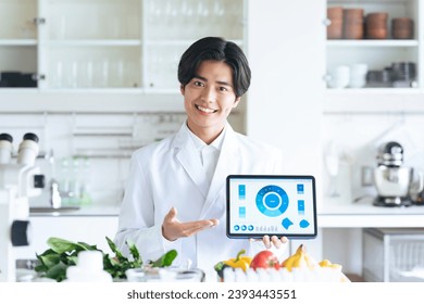 A researcher explaining while showing a screen on a tablet.