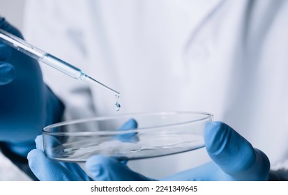 Researcher with glass laboratory chemical test tubes with liquid for analytical , medical, pharmaceutical and scientific research concept. - Powered by Shutterstock