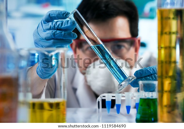 researcher holding test tube with chemist\
material in the investigation lab / chemical engineer working with\
tube test in the research\
laboratory