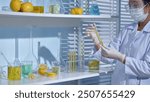 A researcher observes a lemon-flavored solution in a laboratory, surrounded by shelves filled with lemons and glass bottles.. Promotion of lemon-flavored lab or cosmetic products