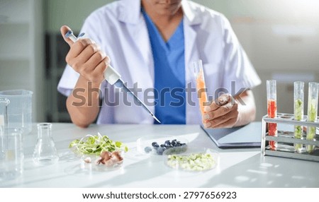 A researcher performs nutritional analysis on food samples in a modern laboratory. 
