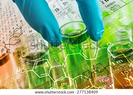 Researcher 's gloved hand holding the test tubes at laboratory, with chemical equations and periodic table background.